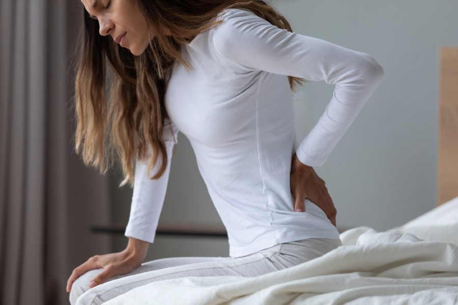 Is there a reason why my back hurts after sleeping?